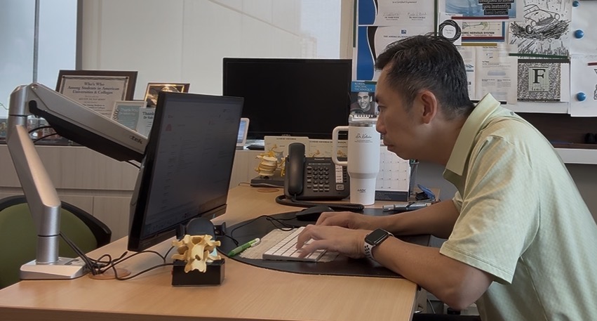 Person hunched over a phone — how poor posture and screen time combine to affect brain function